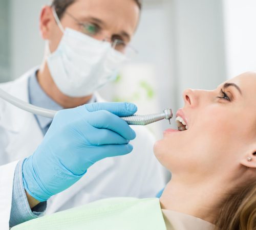 female-patient-at-dental-procedure-using-dental-dr-2022-12-16-18-15-05-utc